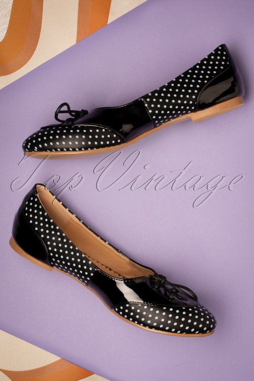 Ballet flats displayed on a poster in black and white polka dots