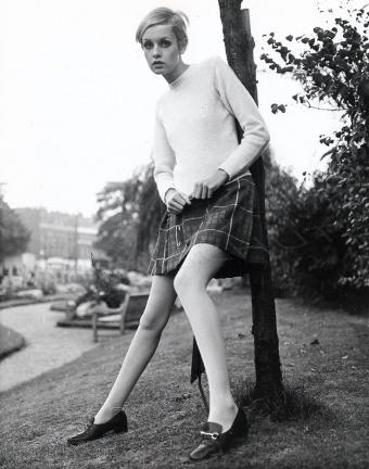 twiggy in a plaid skirt and winter sweater with tights and loafers