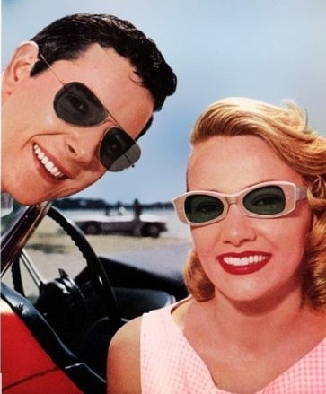 1960's man and woman wearing aviator and ray ban sunglasses