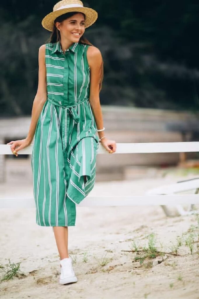 Lady with a straw boater hat and a shirt dress with sneakers