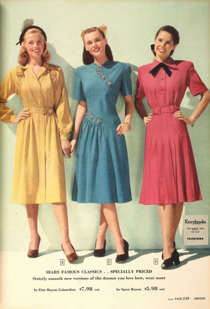 3 1940's models wearing block coloured dresses with belt detail