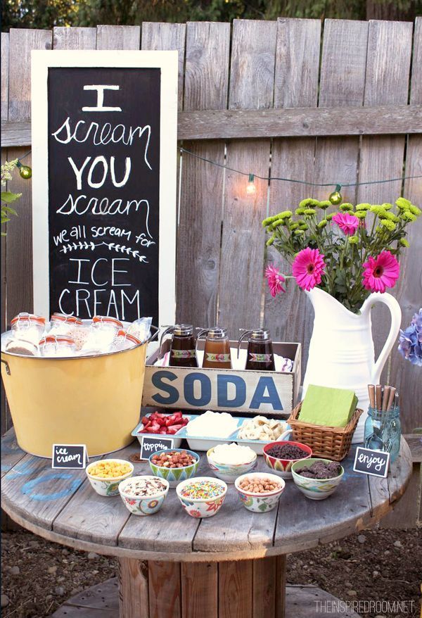 Icecream soda station with assorted toppings jugs and signs