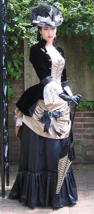 Lady in fitted victorian ruched gown with lace over jacket hat gloves and umbrella to match