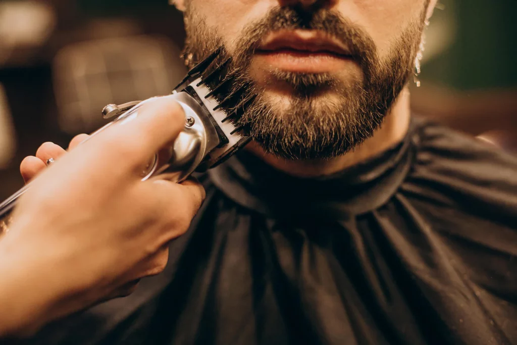 Man having a beard trim with clippers