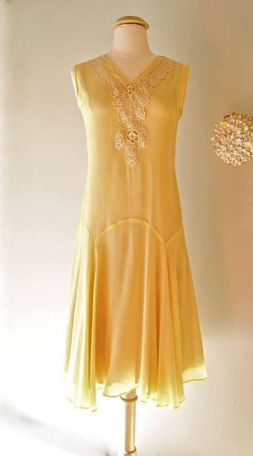 Yellow sleeveless drop waist dress with hankerchief hem