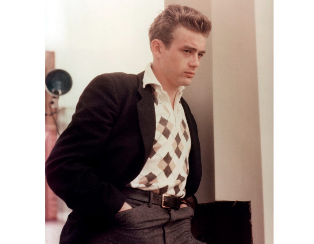 James Dean depicted in a sports jacket suit with tweed vest and shirt with belted pants