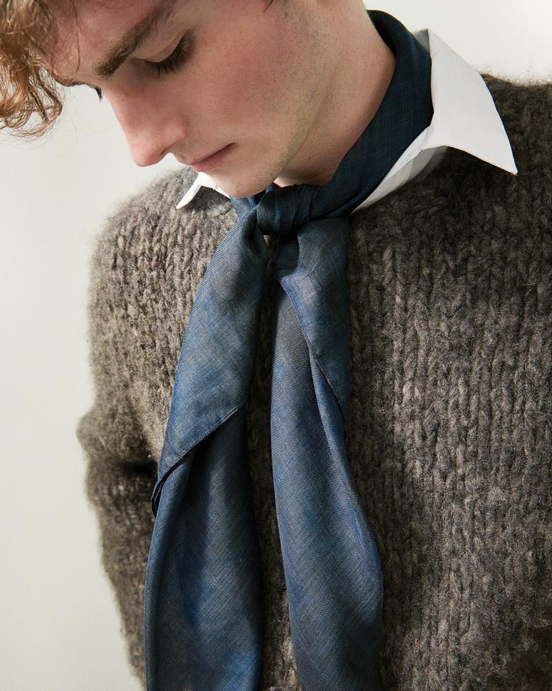 Young man wearing navy neck scarf