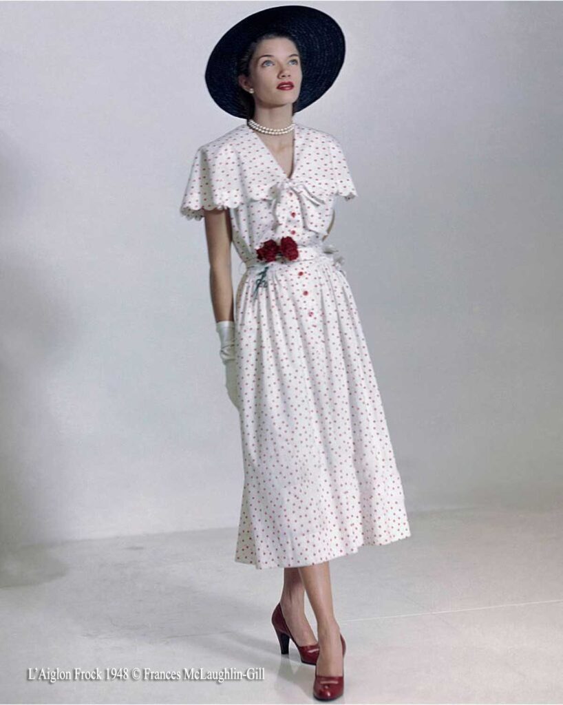 woman in white dress with red polka dots and accessories wearing white gloves and pearls