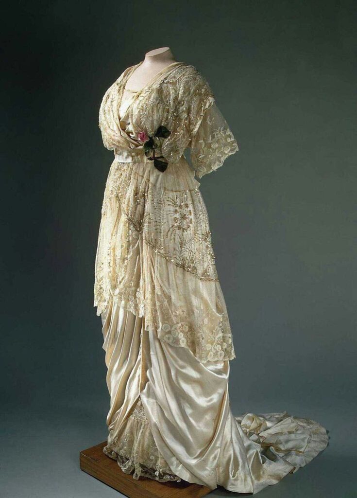 1900's formal evening gown in pale yellow and gold with multiple layers and ruching