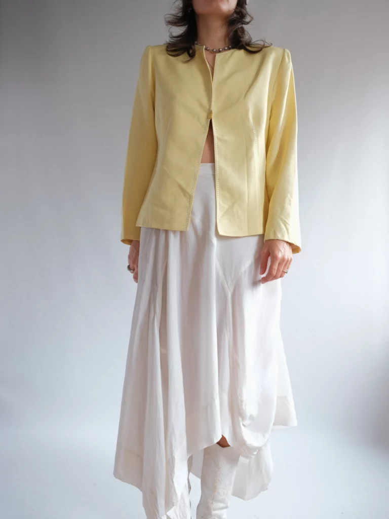 2000's fitted no collar yellow jacket and hankerchief style ivory skirt