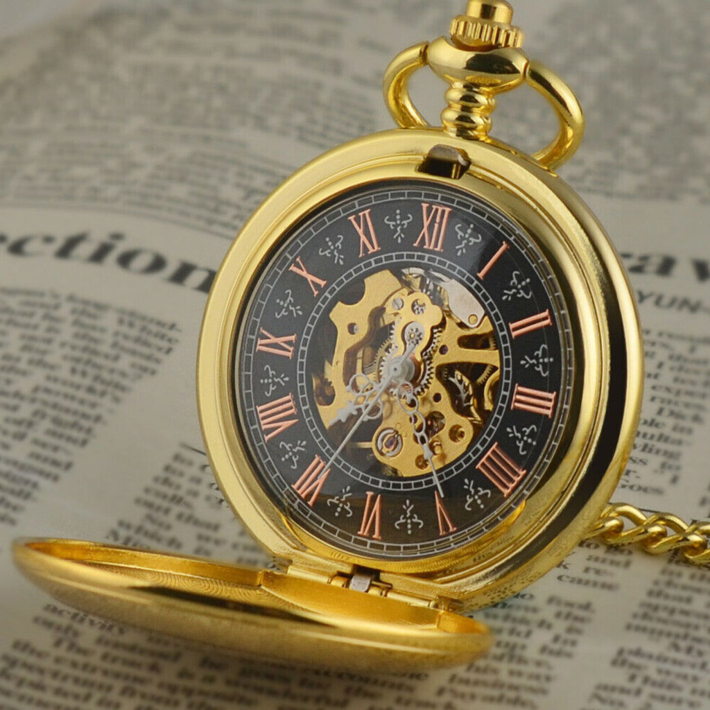 Gold pocket watch with roman numerals and black background exposing mechanical arms