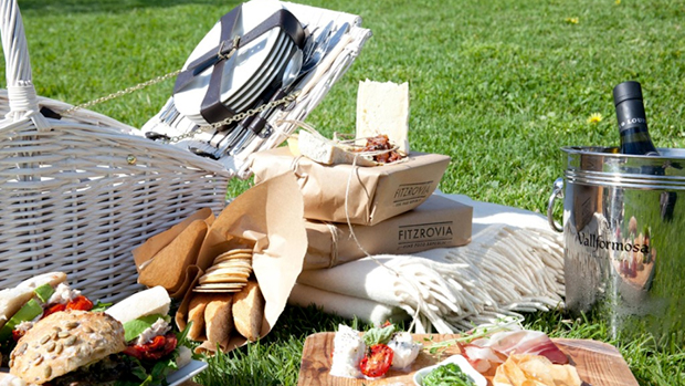 Picnic hamper basket showcasing gourmet food and a champagne bucket