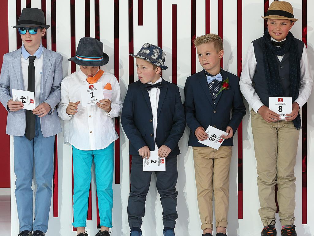 5 boys dressed in dapper gear lining up for family fashions on the field event