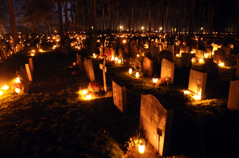 All hallows eve and all saints day candles lit in a cemetery honouring the dead