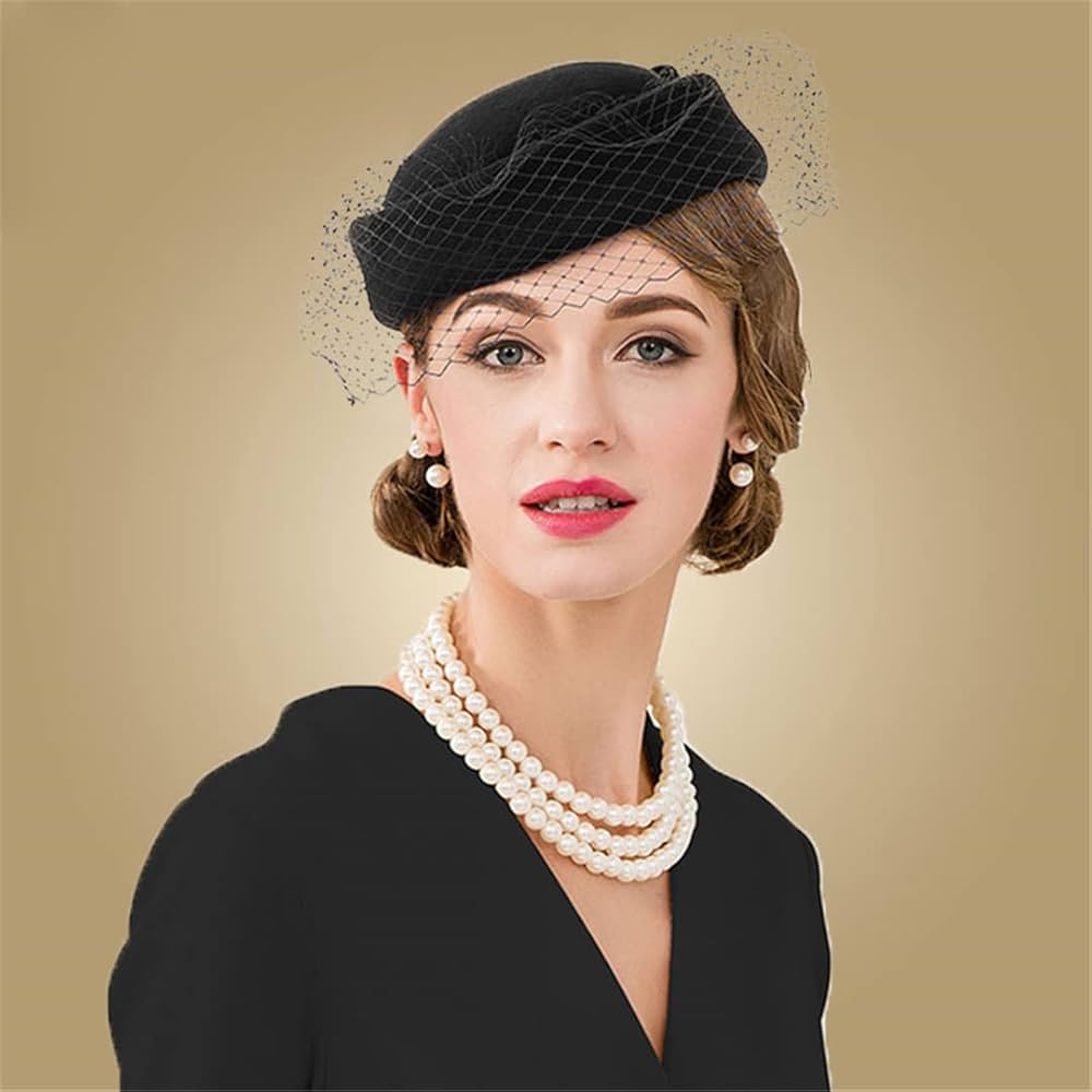 Lady wearing a black pill box hat with pearl jewellery and black dress