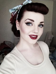 1950's girl with pulled up hair bangs and dark makeup