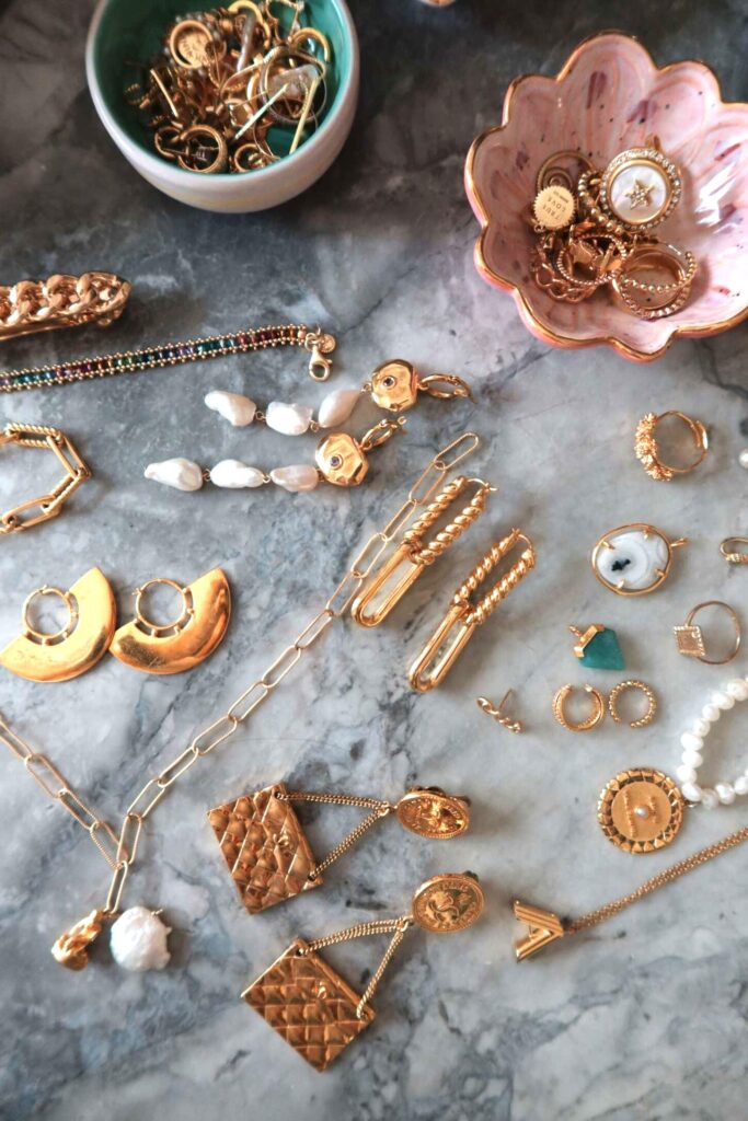 marble table full of antique heirloom jewellery pieces mainly in gold