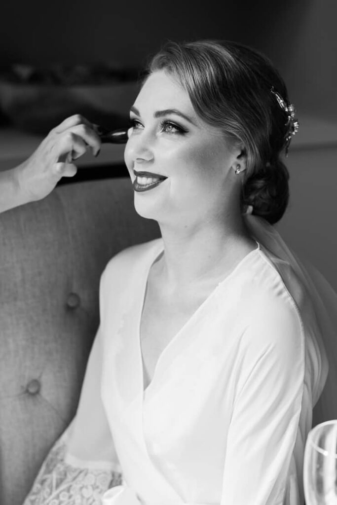 Lady getting her vintage wedding hair and makeup done