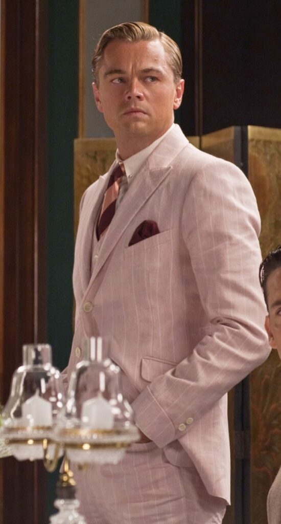 Leonardo Di Caprio in a pink pin striped 3 piece suit and accessories