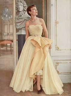 Lady in formal christian dior gold coloured gown with bow detail