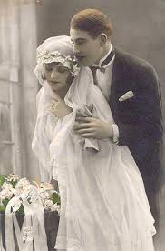 1920's bride and groom in tuxedo and bride in chiffon gown with juliet cap veil