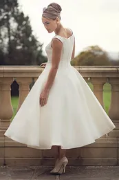 Lady wearing an ivory tea length sleeveless wedding dress