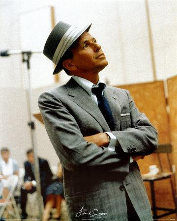 Frank Sinatra, in a tweed suit and fedora hat