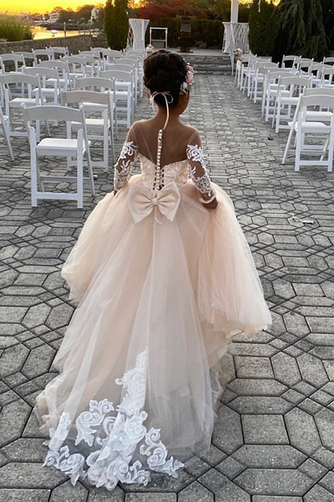 Girl in off the shoulder long peach chiffon dress with back corset and bow detail finished in lace trims