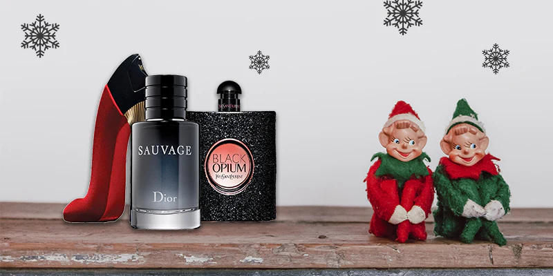 Men's Opium and Sauvage after shave on a table with 2 elves nearby