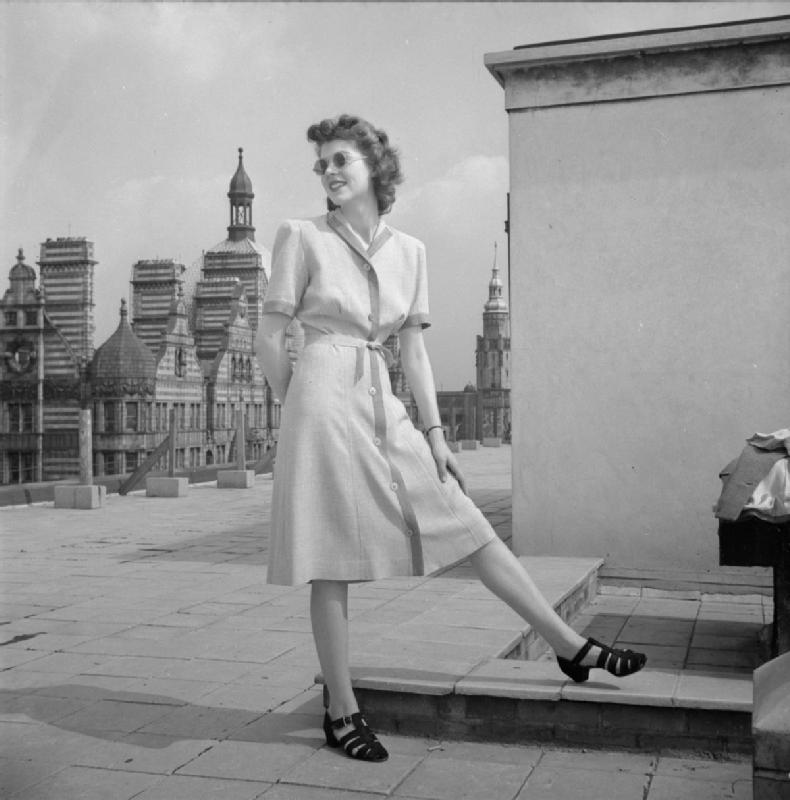 1940's lady in utilitarian dress and plain shoes