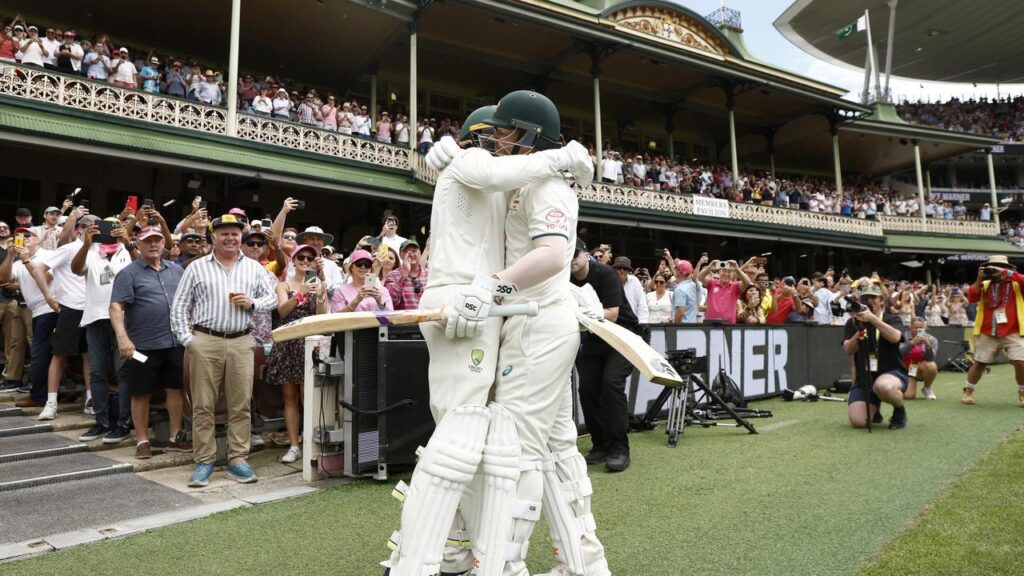 2 Australian cricketers embracing after a match