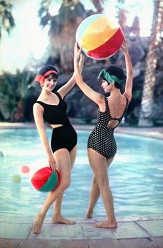 2 ladies holding up beach balls at a pool in tropical Qld in 1970's bathing suits