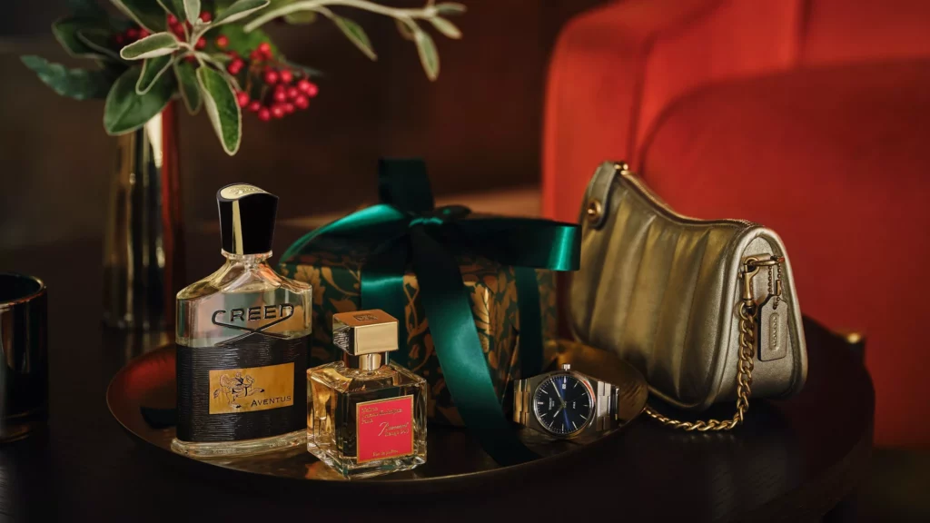 grooming products and fragrances on a desk with gifts