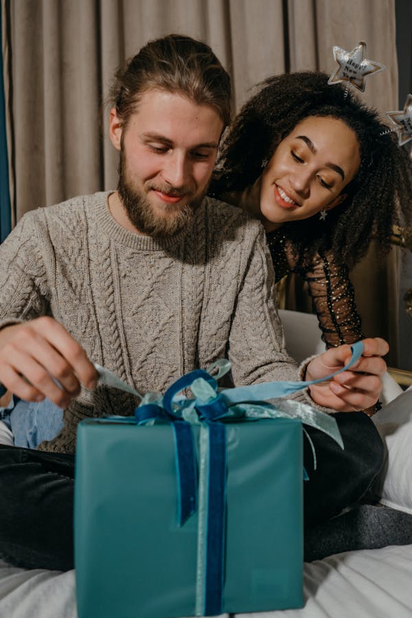 Bearded man with a woman opening a christmas gift