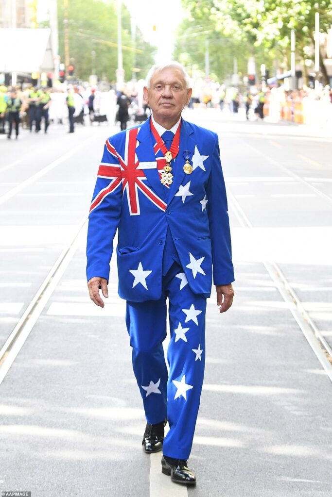 Man walking on a road wearing an australian flag suit