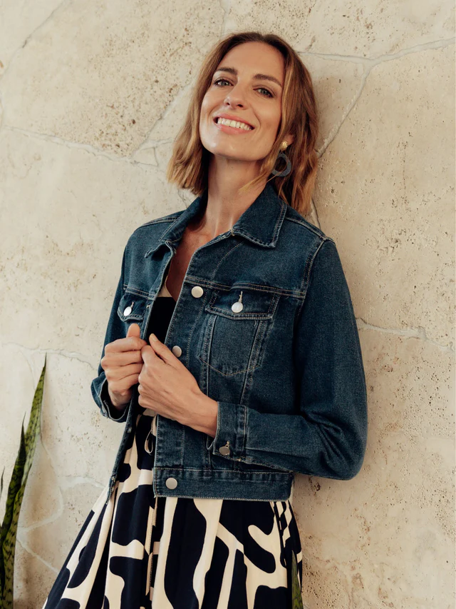 woman wearing a two toned dress under a denim jacket