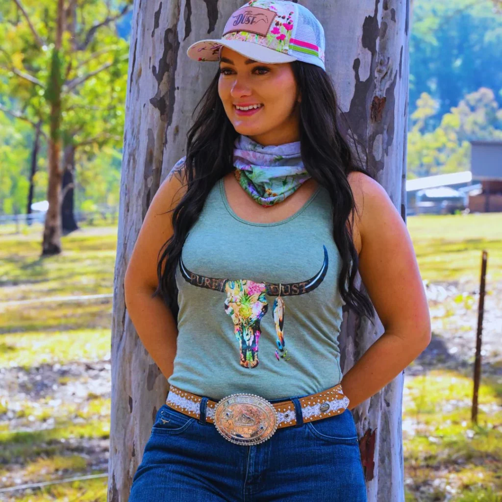 Cowgirl in a cap with neck scalf and bull design top with large belt