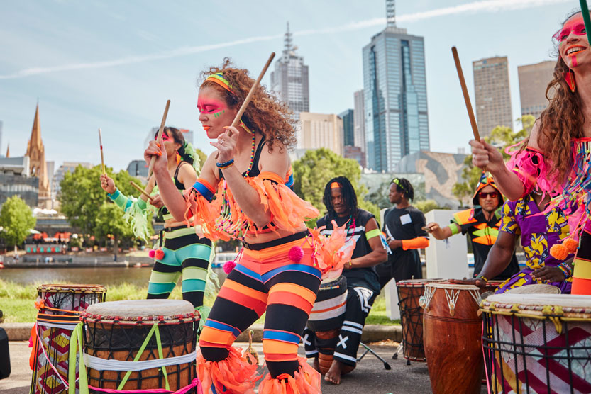 Cultural band performing in vivid costumes at Moomba