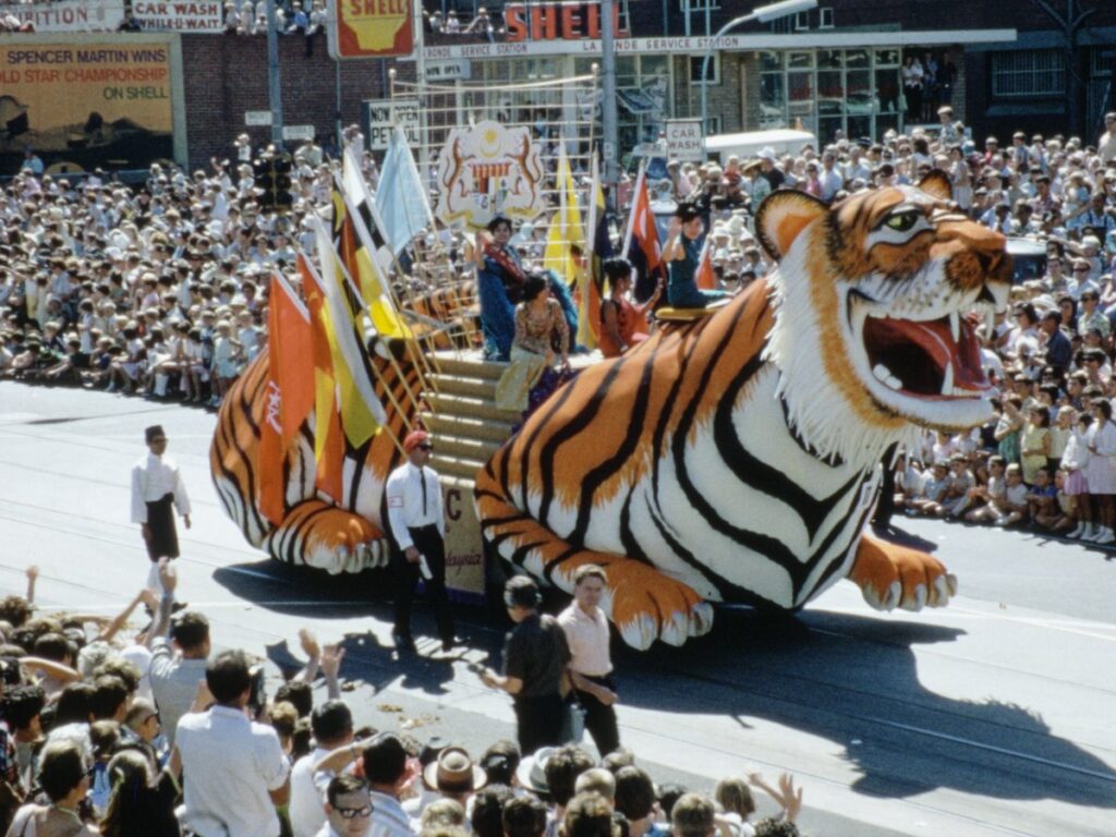 Cultural float with performers on parade - 20th century