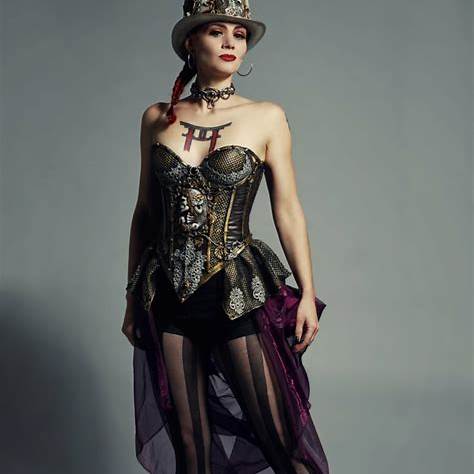 Woman in a top hat, corset style top and sheer skirt with ruffles