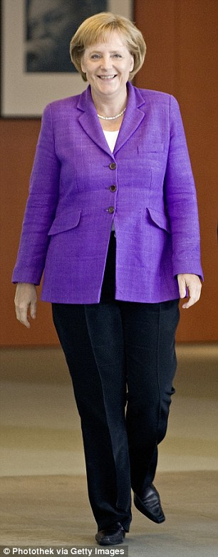 Angela Merkel in a suit jacket and black pants