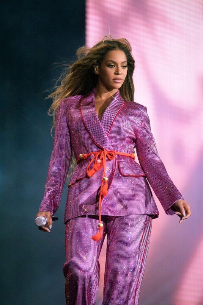 Beyonce in a glittery 2 piece pants suit with tie belt