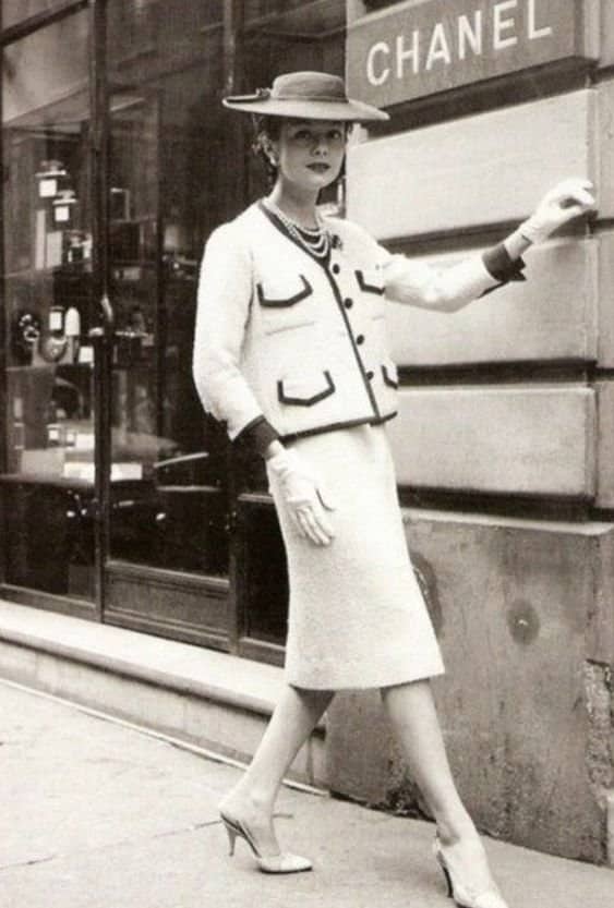 Model wearing chanel suit outside the chanel building