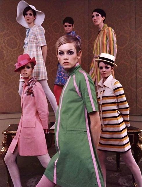 Twiggy and other models wearing striped hues dresses and accessorized with hats