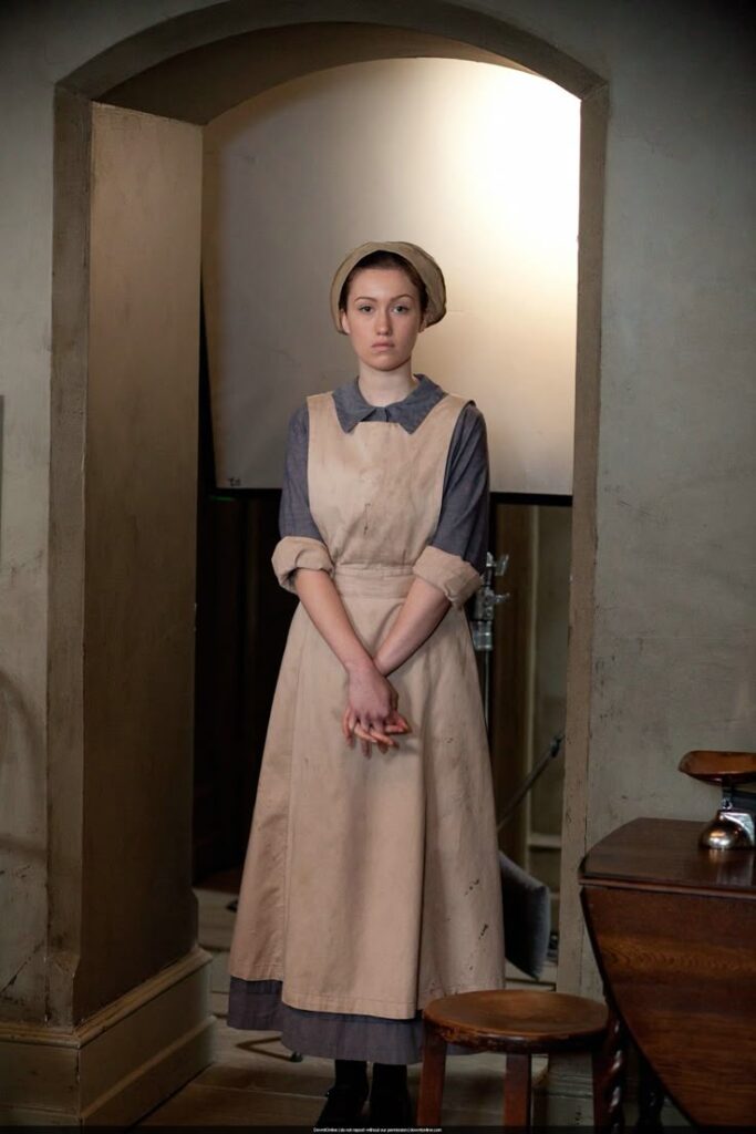 An assistant cook in long dress and apron costume