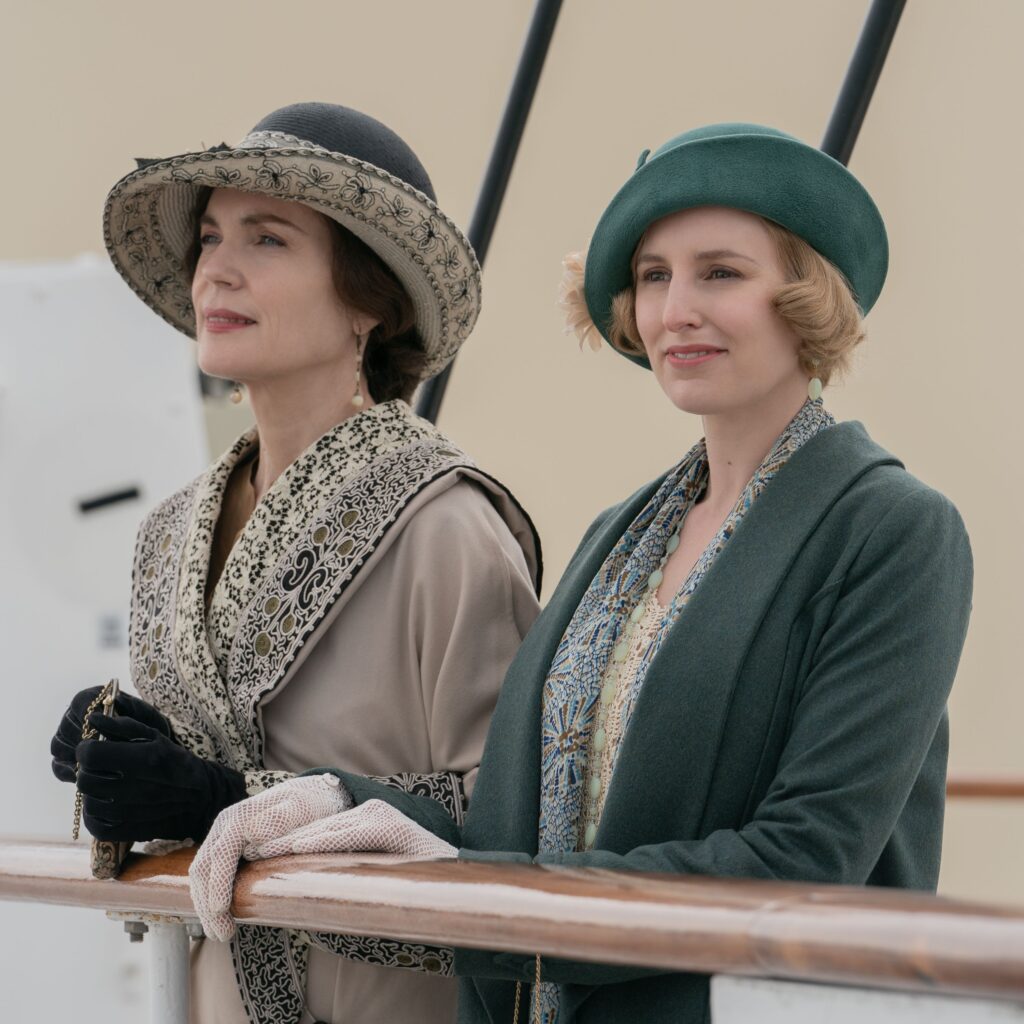 Edith and Cora in loose coats with swept up hats 1920's era