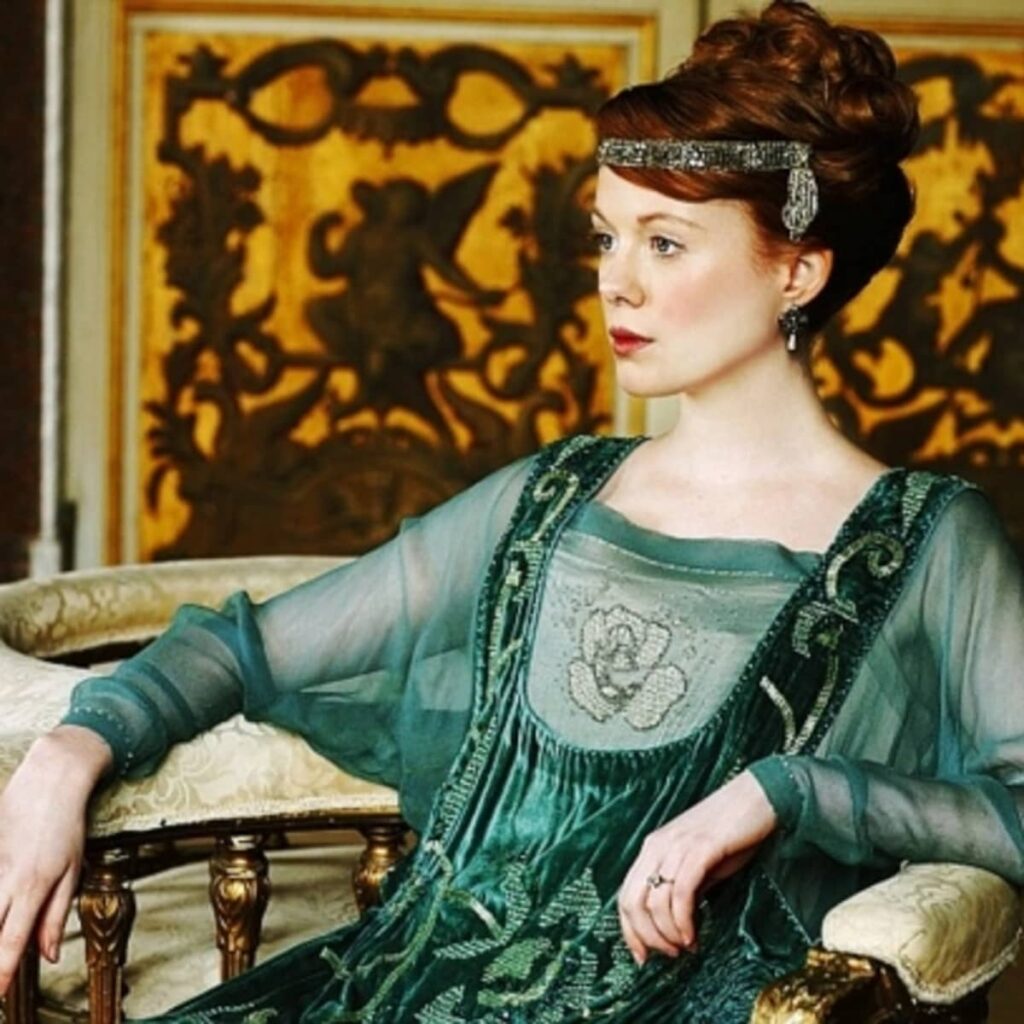 Socialite in a jade green dress with head beading and a chiffon beaded dress