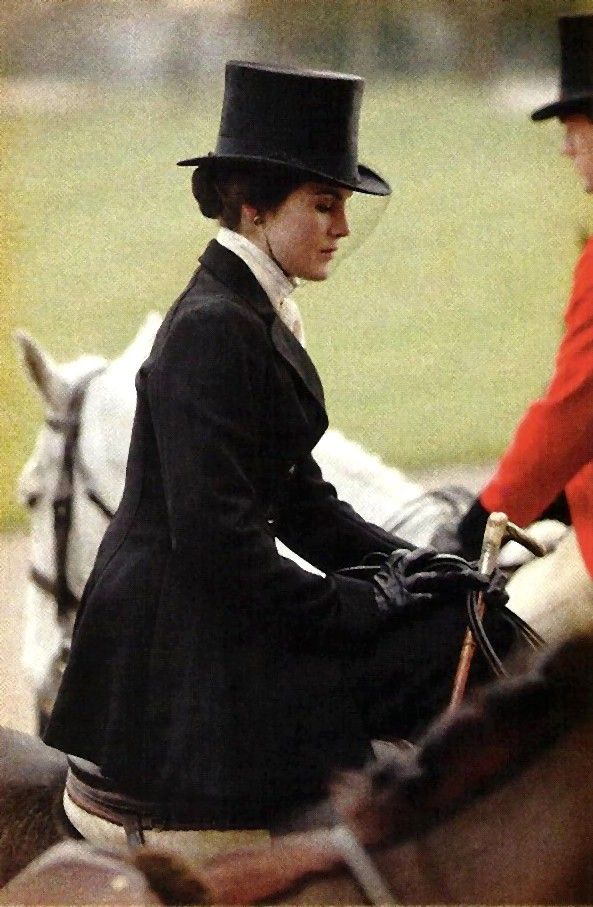 Lady Mary on horseback sidesaddle in a long black coat and skirt with top hat and white shirt
