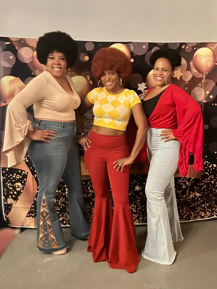 3 ladies with afro hairstyles in flared pants and tight short tops