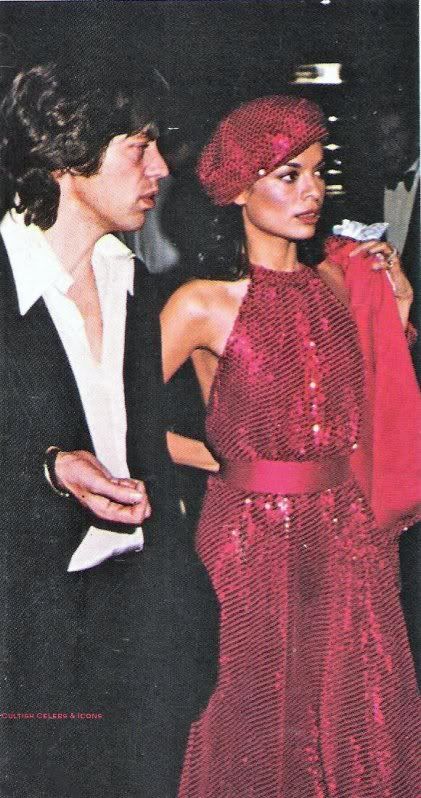 Bianca and Mich Jagger shes dressed in a hot pink glittering sleevless dress with matching beret